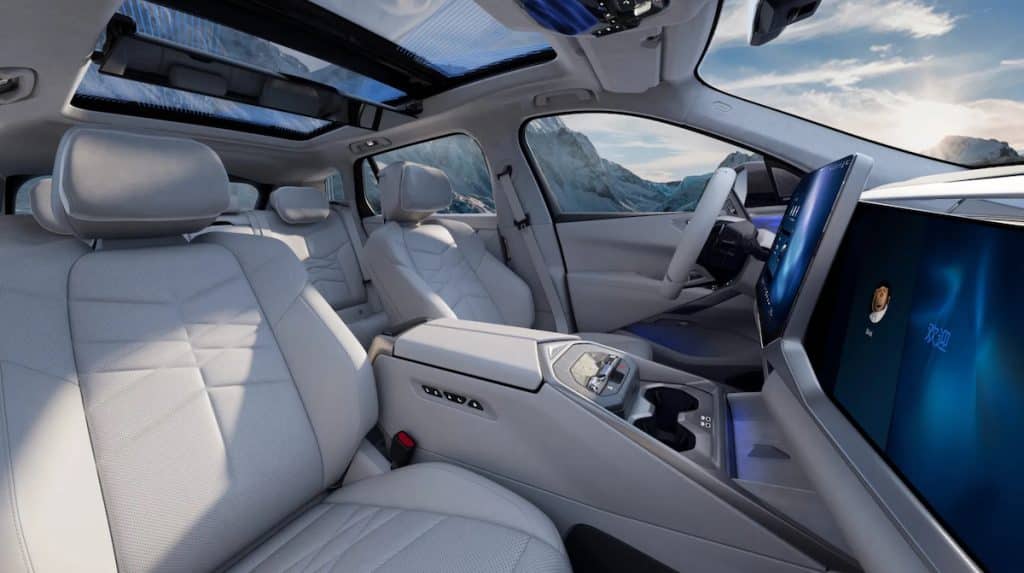 Luxurious light-gray car interior with panoramic sunroof and large touchscreen dashboard